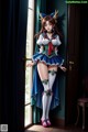 A woman in a sailor outfit standing in front of a door.